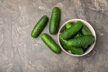 Cucumber on wooden background. Slice of cucumber on background. Fresh organic green cucumbers gherkin. Vegan. Salad ingredient. Farm vegetables. Cut vegetables with knife. Space for text. Copy space
