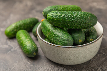 Cucumber on wooden background. Slice of cucumber on background. Fresh organic green cucumbers gherkin. Vegan. Salad ingredient. Farm vegetables. Cut vegetables with knife. Space for text. Copy space