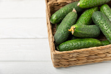 Cucumber on wooden background. Slice of cucumber on background. Fresh organic green cucumbers gherkin. Vegan. Salad ingredient. Farm vegetables. Cut vegetables with knife. Space for text. Copy space