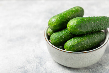 Cucumber on wooden background. Slice of cucumber on background. Fresh organic green cucumbers gherkin. Vegan. Salad ingredient. Farm vegetables. Cut vegetables with knife. Space for text. Copy space