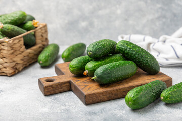 Cucumber on wooden background. Slice of cucumber on background. Fresh organic green cucumbers gherkin. Vegan. Salad ingredient. Farm vegetables. Cut vegetables with knife. Space for text. Copy space
