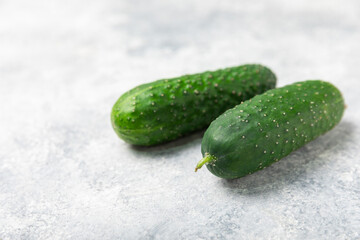 Cucumber on wooden background. Slice of cucumber on background. Fresh organic green cucumbers gherkin. Vegan. Salad ingredient. Farm vegetables. Cut vegetables with knife. Space for text. Copy space