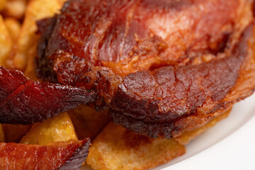 Macro shot of grilled smoked ham with fried potatoes
