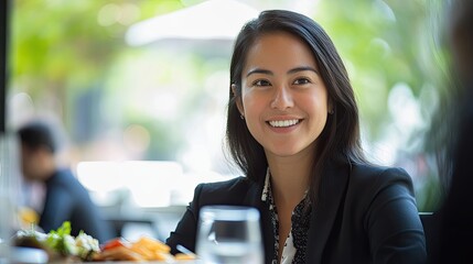 Smiling businesswoman in a restaurant.