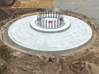 Aerial view of a newly constructed foundation of a wind turbine made of concrete, wind turbine, wind energy, reinforced concrete, construction site, energy transition