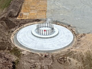 Aerial view of a newly constructed foundation of a wind turbine made of concrete, wind turbine, wind energy, reinforced concrete, construction site, energy transition
