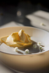 Soft butter in sunlight with white decorative flowers on a ceramic plate
Minimalist food styling image of soft butter served on a white plate with delicate white flowers and warm natural light. Ideal