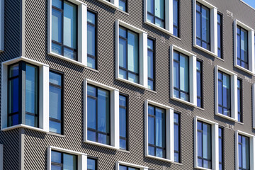 Modern building facade featuring symmetrical windows and striped walls in Brighton, Massachusetts, USA

