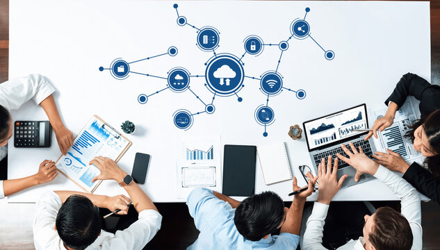 An engaged team collaborates in a modern workspace, analyzing data and discussing cloud technology strategies to enhance business performance and innovation. Amity