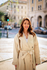 Obraz premium Attractive woman wearing trench coat and cheerful smiling on the city street