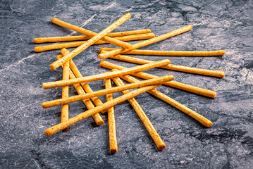 Crunchy Breadsticks on Dark Stone Surface