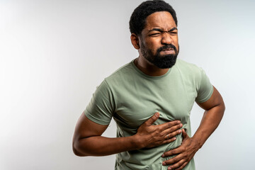 Man Suffering From Stomach Ache. Unhealthy man suffering with stomach pain, feeling unwell. Acid...