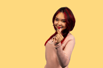 Woman making heart gesture with fingers