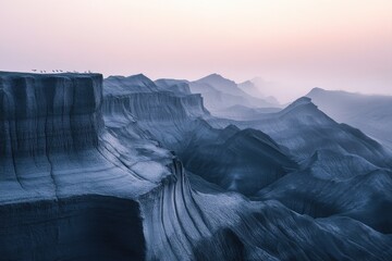 A serene landscape of layered hills in muted blues and grays under a pale pink sky, dotted with tiny birds on a cliff edge.