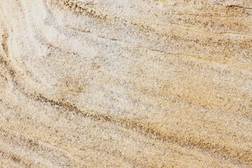 Natural sandstone texture with intricate layers, swirls, and patterns in warm earth tones. Perfect for backgrounds, design projects, geology, and nature-themed content.