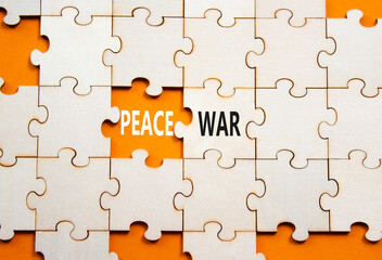 Fototapeta premium War or Peace symbol. Concept word War or Peace on wooden puzzle. Beautiful orange background. Business and War or Peace concept. Copy space