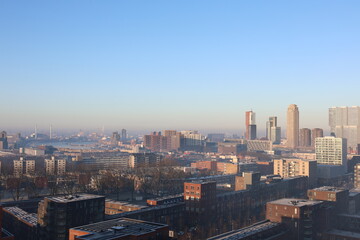 A misty landscape photo with the Nieuwe Maas River in Rotterdam, the Netherlands, in the background.