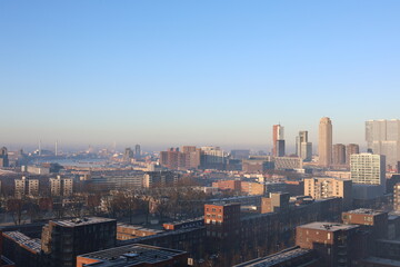 A misty landscape photo with the Nieuwe Maas River in Rotterdam, the Netherlands, in the background.