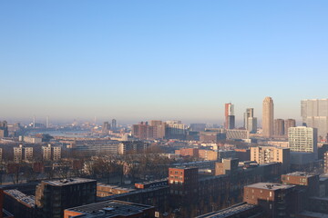 A misty landscape photo with the Nieuwe Maas River in Rotterdam, the Netherlands, in the background.