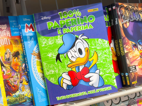 Disney comic books featuring donald duck displayed on shelves