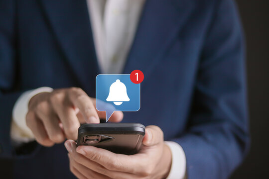 Alert notification concept. Reminder, Push Notifications, Web Reminders, Time Table and Announcements. Person using smartphone with bell notification icon on virtual screen.