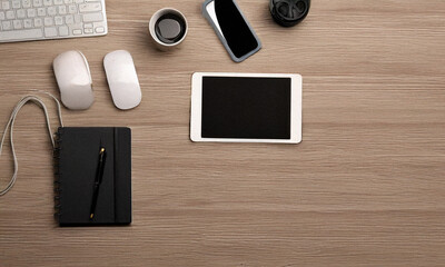 Flat lay of tech gadgets on wooden desk in minimal style, top view

