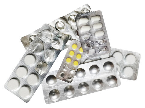 An overhead shot of various pharmaceutical blister packs, some full with white and yellow pills, others partially used or empty. The metallic foil packaging with distinct round and oval shapes suggest - Powered by Adobe