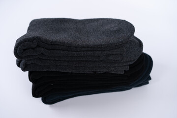 Warm cotton socks stacked neatly, ideal for cold weather, showcasing a simple yet practical design, perfect for winter outfits or cozy home settings