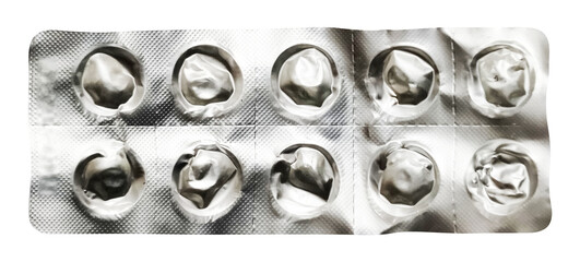 A top-down view of a completely empty pharmaceutical blister pack, with all ten compartments pressed out and the metallic foil crumpled where pills once were. The stark emptiness against the light