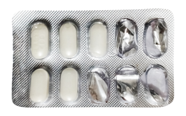 An overhead view of a blister pack containing off-white or light beige, oval-shaped tablets. Several compartments are empty and visibly pressed, indicating that some medication has been dispensed