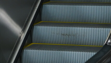 Obraz premium Station escalators. Empty escalator steps, moving staircase