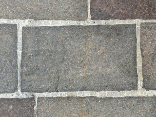 Fototapeta premium Close-up of textured stone pavement with light grout