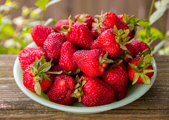 A bowlful of vibrant, freshly picked strawberries for a healthy summer snack or dessert