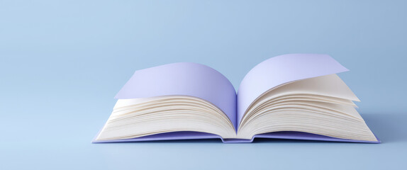 An open book with lavender pages is lying on a surface. Learning and creativity concept