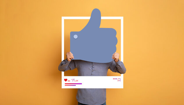 A person holds a large thumbs up symbol in a bright yellow background, symbolizing approval and social media interaction.