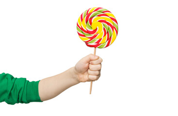 Child's hand holding big colorful lollipop candy on stick, isolated on white background.