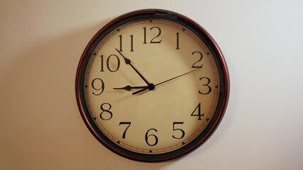 Retro clock ticking. The second hand is moving slowly. The time is running in the morning. Worn old analogue timepiece at home on a white wall. - Powered by Adobe
