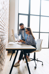 Business partners analyzing financial report in modern office