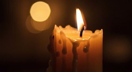 A warm and evocative scene showcasing a burning candle, its soft glow illuminating the surrounding darkness with a comforting radiance.