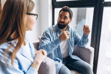 Patient explaining his problems to psychologist during therapy session