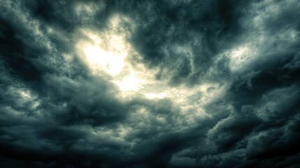 Fototapeta premium Dark and Dramatic Storm Clouds with Bright Light Breaking Through