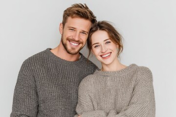 Happy couple in casual clothes hugging each other, white background
