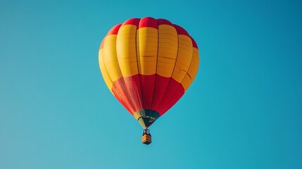 Naklejka premium A brightly colored hot air balloon floats serenely against a vibrant, clear blue sky.