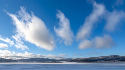 Obraz premium Frozen Lake Winter Landscape Snowy Mountains Blue Sky White Clouds
