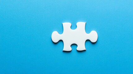 Obraz premium A single, glossy blue puzzle piece rests on a solid blue background.