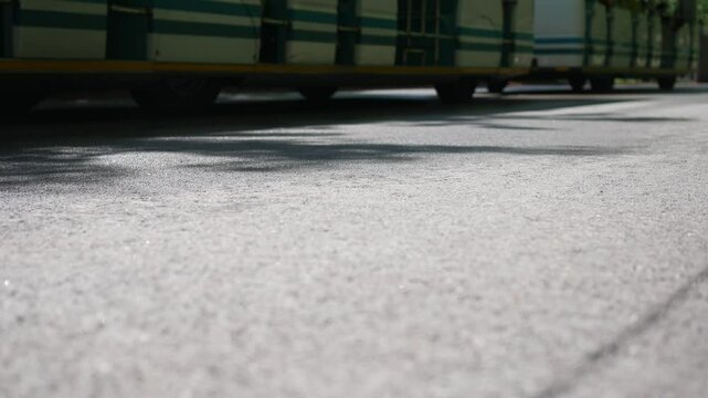 Trolley of Carts moves Pedestrians in Amusement Park or Zoo or Outdoor Venue