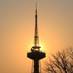 Cell tower against sunset