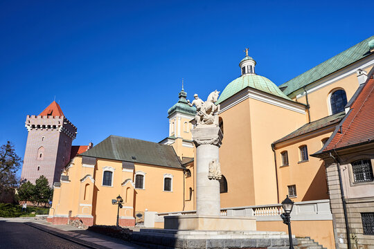 statue of an uhlan, baroque church and tower of the medieval royal castle in the city of Poznan