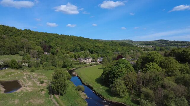 scenic aerial drone shot of the river calder at Brearley fields wetlands between mytholmroyd and Luddenden Foot surrounded by west yorkshire scenery in summer