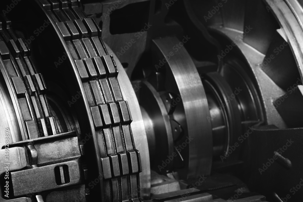 Poster A dark black close up of a machine with many gears and discs. concept of powerful industrial energy of complexity and intricacy, and a sense of awe at engineering behind machine.